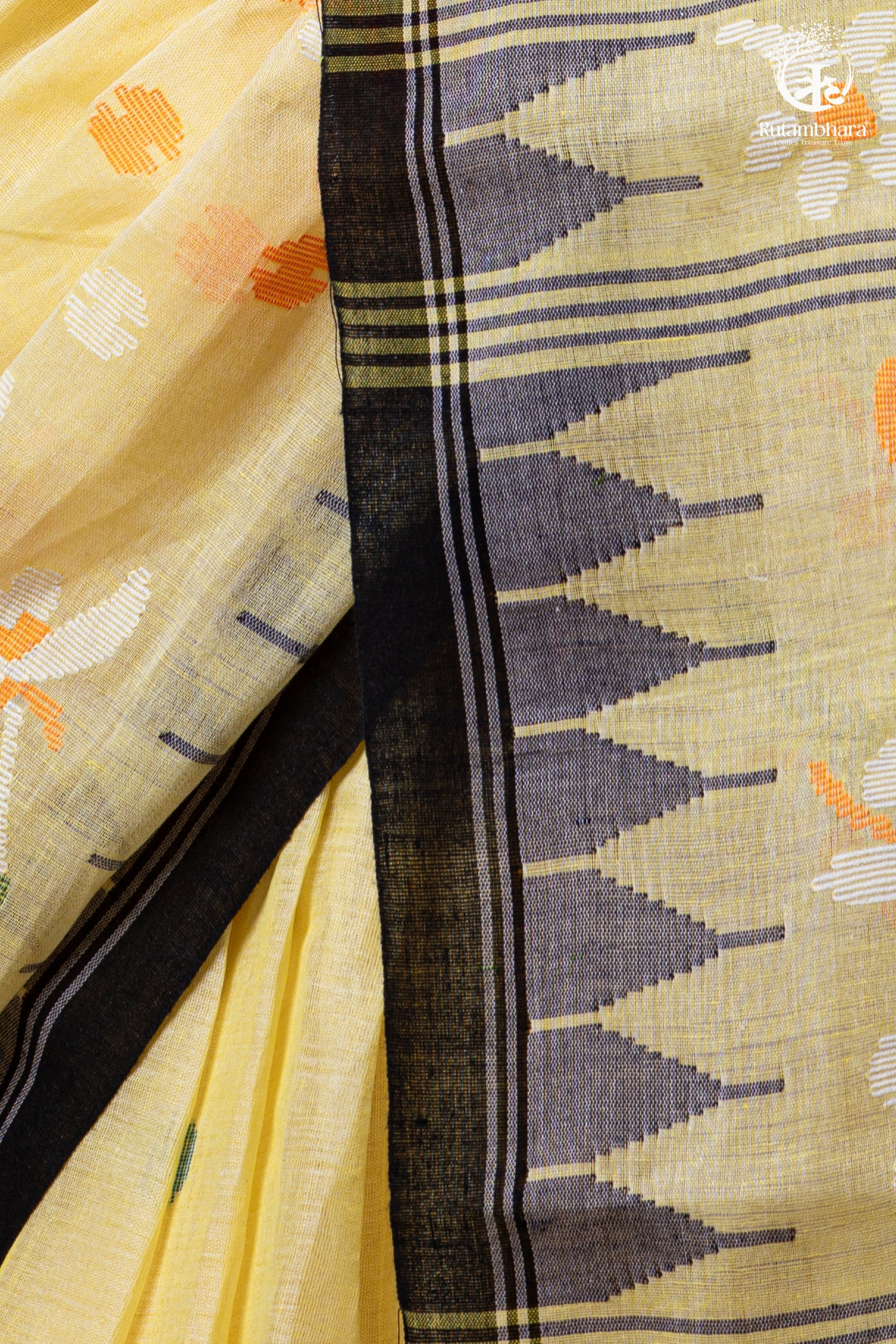 Close-up of a yellow fabric with black and orange patterns, featuring a brand logo in the corner.