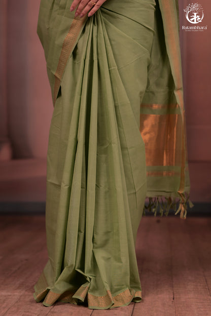 Green saree with a blurred background