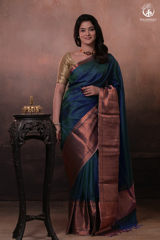 Bhadra - Teal Blue Plain Handwoven Silk Saree With Copper Zari Border