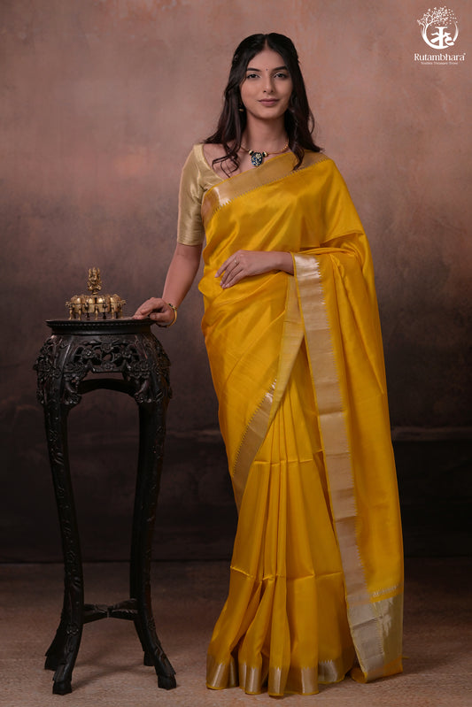 Bhadra - Turmeric Yellow Plain Handwoven Silk Saree With Silver Zari Border