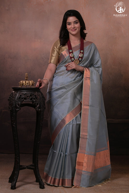 Bhadra - Powder Blue Plain Handwoven Silk Saree With Copper Zari Border