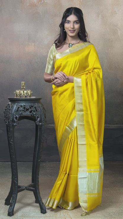Bhadra - Turmeric Yellow Plain Handwoven Silk Saree With Silver Zari Border